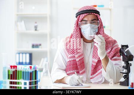 Arab doctor chemist studying new virus in lab Stock Photo