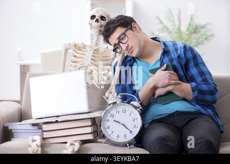 Student studying with skeleton preparing for exams Stock Photo