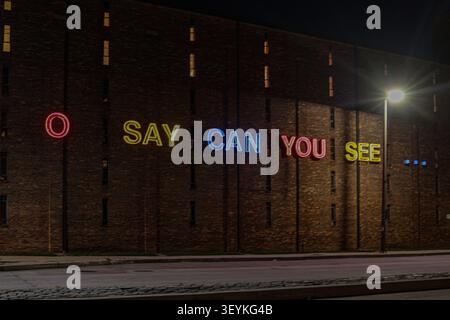 Baltimore, USA. 03rd July, 2026. BALTIMORE, Maryland, USA. An 11-foot glowing neon "O Say Can You See" sign illuminates the exterior of the Jim Rouse Visionary Center at the American Visionary Art Museum. Positioned near Fort McHenry, where Francis Scott Key wrote the National Anthem, the public art installation stands as a vibrant tribute to the United States ahead of the nation's 250th anniversary. 3, July, 2026. Photo Credit: Robyn Stevens Brody/Alamy. Credit: Sipa USA/Alamy Live News Stock Photo
