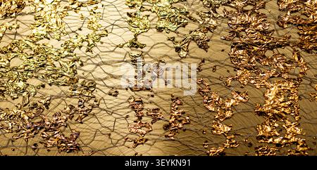 Golden decorative background in reflective texture. Golden shimmering texture on foil surface. Golden abstract gold wallpaper for premium. Golden Stock Photo
