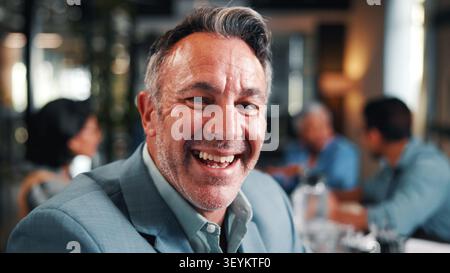 Portrait, businessman and laugh in office with meeting, pride and funny joke for advertising career. Happy, mature person and team in creative agency Stock Photo