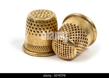 Antique copper thimbles for sewing. Close-up items on a white background. Stock Photo
