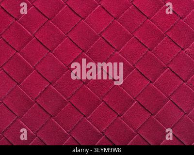 Woven suede leather texture background in burgundy color with diagonal interlaced pattern, close-up authentic photograph Stock Photo