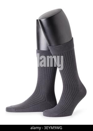 Pair of men's grey ribbed socks on black leg mannequins, classic business dress socks, isolated on white background Stock Photo