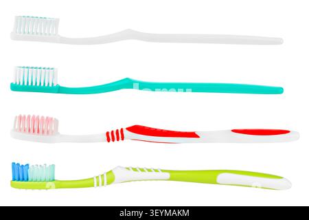Set of four colorful plastic toothbrushes isolated on white background. Stock Photo