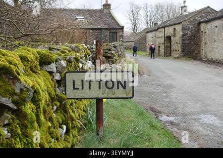 Two Elderly Men (Hikers) Walking through the Farming Hamlet of Litton in Littondale, Yorkshire Dales National Park, Yorkshire, England, UK Stock Photo