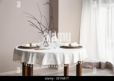 Minimalist dining table set for two with natural decor Stock Photo