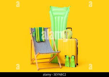 Summer travel and beach vacation essentials on yellow background Stock Photo