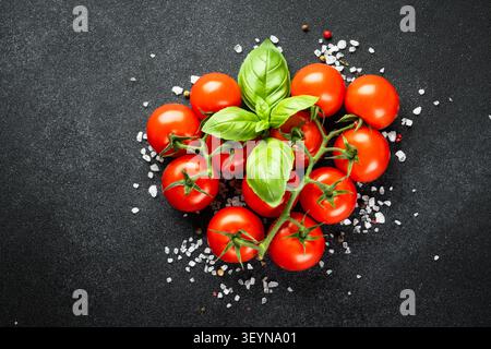 Cherry tomatoes on black table. Stock Photo