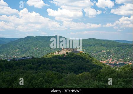 Close high-angle view of the medieval Visegrad Upper Castle fortress on a hill with a valley town and hills in the background, Hungary. Stock Photo