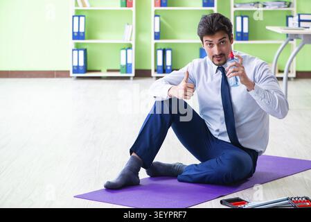 Employee doing exercises during break at work Stock Photo