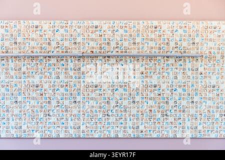 mosaic wall panel with railing on pink kitchen wall during home renovation Stock Photo