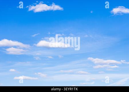 many light cumulus clouds in blue sky on sunny April day Stock Photo