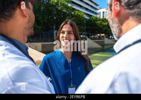 Medical team having outdoor meeting, discussing health care concepts Stock Photo