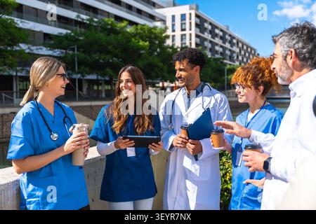Medical team collaborating and sharing ideas outdoors Stock Photo