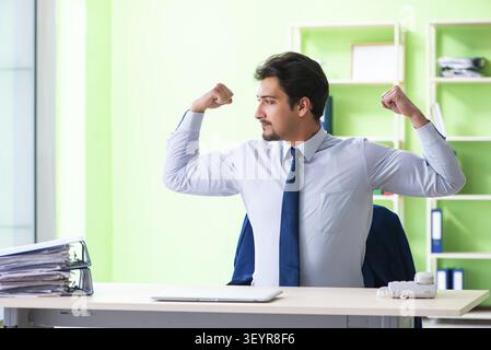 Employee doing exercises during break at work Stock Photo