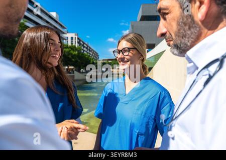 Healthcare professionals collaborating and discussing outdoors Stock Photo