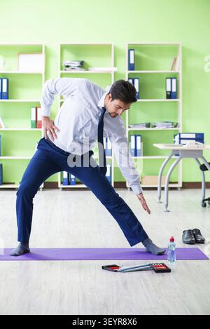 Employee doing exercises during break at work Stock Photo