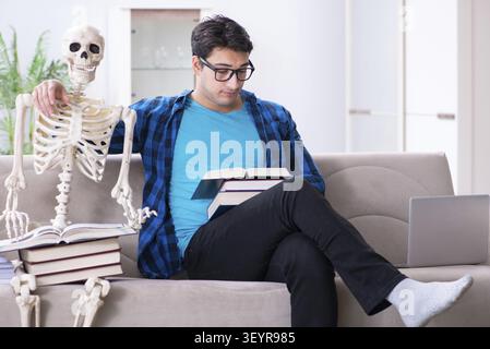 Student studying with skeleton preparing for exams Stock Photo