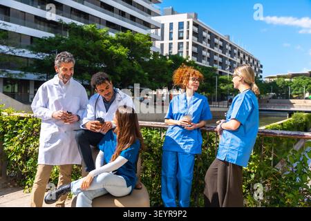 Diverse medical professionals discussing during outdoor break Stock Photo