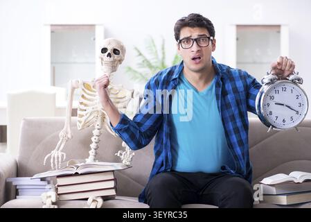 Student studying with skeleton preparing for exams Stock Photo