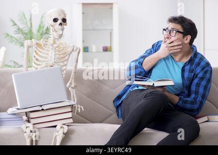 Student studying with skeleton preparing for exams Stock Photo