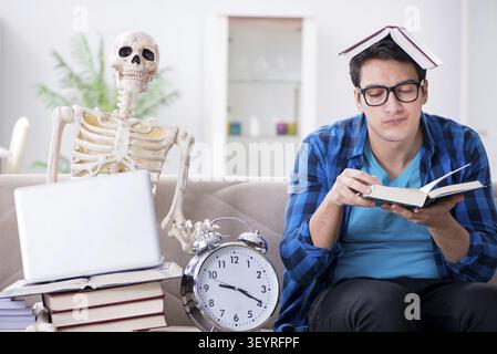 Student studying with skeleton preparing for exams Stock Photo