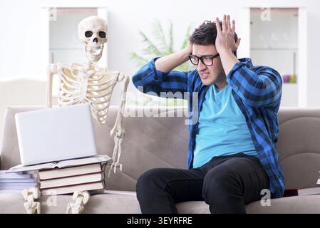 Student studying with skeleton preparing for exams Stock Photo