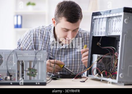 Young technician repairing computer in workshop Stock Photo