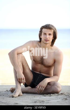 Portrait of young and handsome guy on the beach Stock Photo