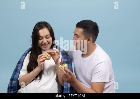Young couple looking at a smartphone with surprise and shock Stock Photo