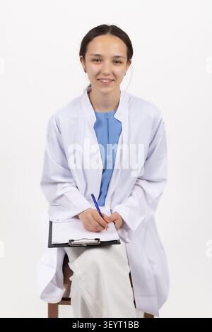 Medical professional holding clipboard taking notes Stock Photo