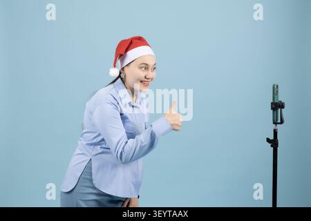 Female vlogger recording a festive video on a mobile smartphone Stock Photo