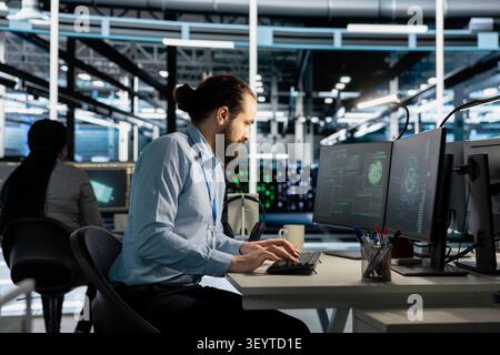 Software developer works on a computer to monitor AI systems, neural networks and server infrastructure. Stock Photo
