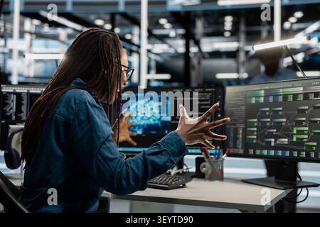 Delighted admin celebrates progress after making data center equipment run artificial intelligence and machine learning tools. Stock Photo