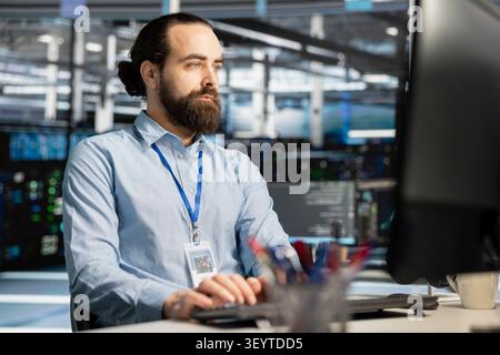 Data center engineer manages databases supporting AI applications and data mining in a server facility. Stock Photo