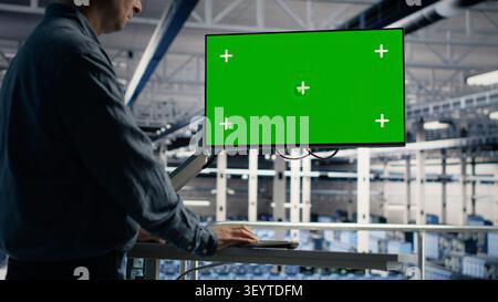 IT specialist uses a chroma key computer in a data center for diagnostics, server monitoring and screen replacement. Stock Photo