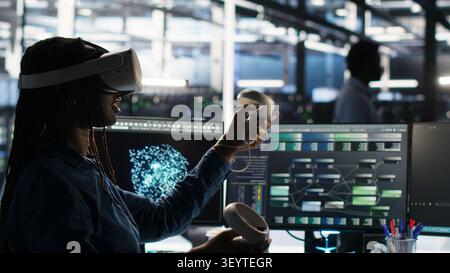 Data center engineer uses virtual reality and node tree software to analyze datasets and system performance. Stock Photo