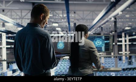 IT colleagues collaborate in a data center while reviewing AI diagnostics and infrastructure performance. Stock Photo
