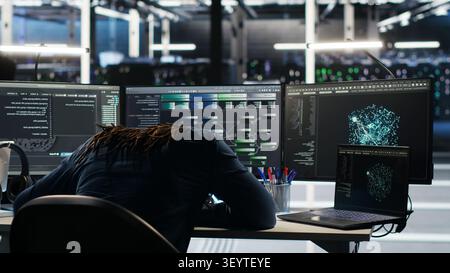 Frustrated data center worker reacts to malfunctioning node tree software and technical errors during AI analysis. Stock Photo