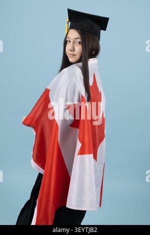 Proud graduate student holding a national flag celebrating success Stock Photo