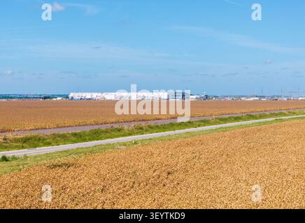 Large AI data center in Hutto, Texas, near Austin, set in rural area with heat haze from the farmland crops blurring the view of the construction Stock Photo