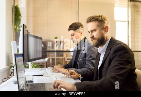 Two business analysts accountants team working on finance data in modern office Stock Photo