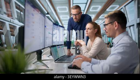 Human Resources Manager Leads Diverse Team Reviewing Payroll Software Features. Stock Photo