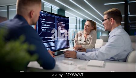 Diverse Team Of Software Engineers Collaborating On Secure Coding Projects. Stock Photo