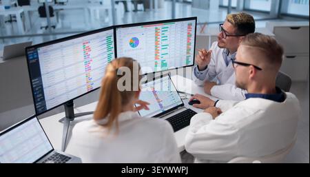Medical Biller And Team Work Together Reviewing Hospital Billing Data. Stock Photo