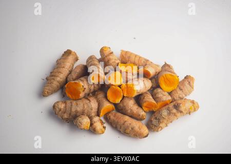 Turmeric root displayed on a plain background Stock Photo