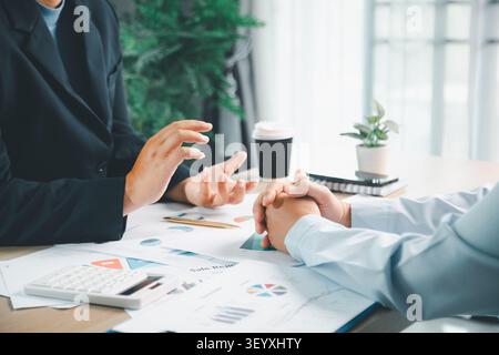 Business team using laptop and tablet in modern office, representing digital finance workflow, accounting report management and online business collab Stock Photo
