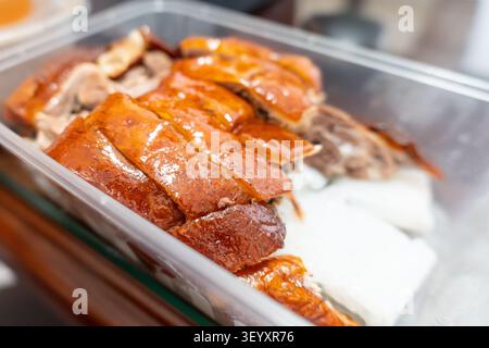Crispy Roast Duck Sliced in Clear Takeout Container, Hong Kong Street Food Stock Photo