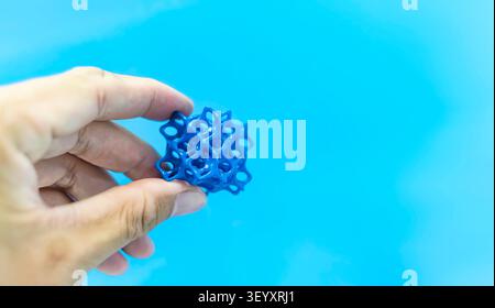 hand with flexible object printed on 3d printer close-up Stock Photo